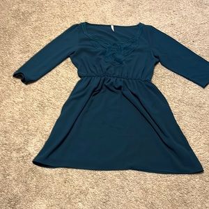 Dark green 3/4 sleeve cinched dress with lace neckline.